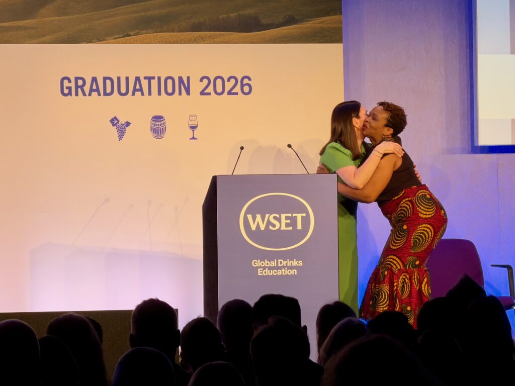 IWC Instructor Deniece Bourne embraces WSET CEO Michelle Brampton on-stage at the Class of 2025 Graduation ceremony in London UK.